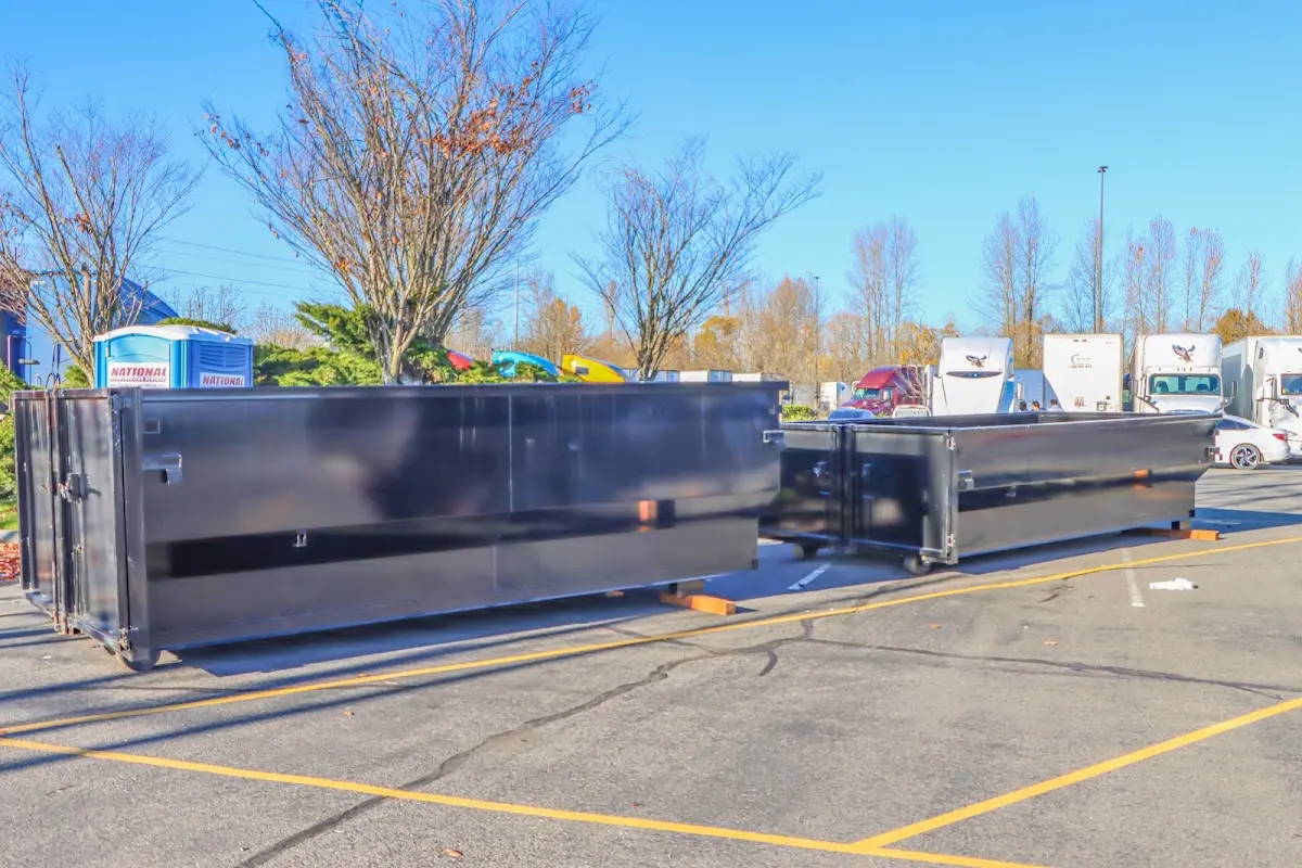 Professional dumpster rental service with roll-off container on residential driveway in Garland